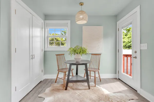 a view of a dining room with furniture window and wooden floor