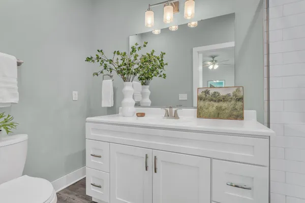a bathroom with a sink a toilet and a mirror