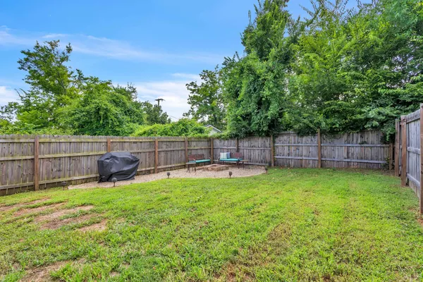 a view of a backyard with a small cabin and a slide
