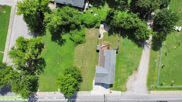 an aerial view of a house with a yard