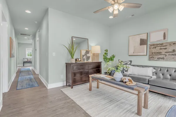 a living room with furniture and a chandelier