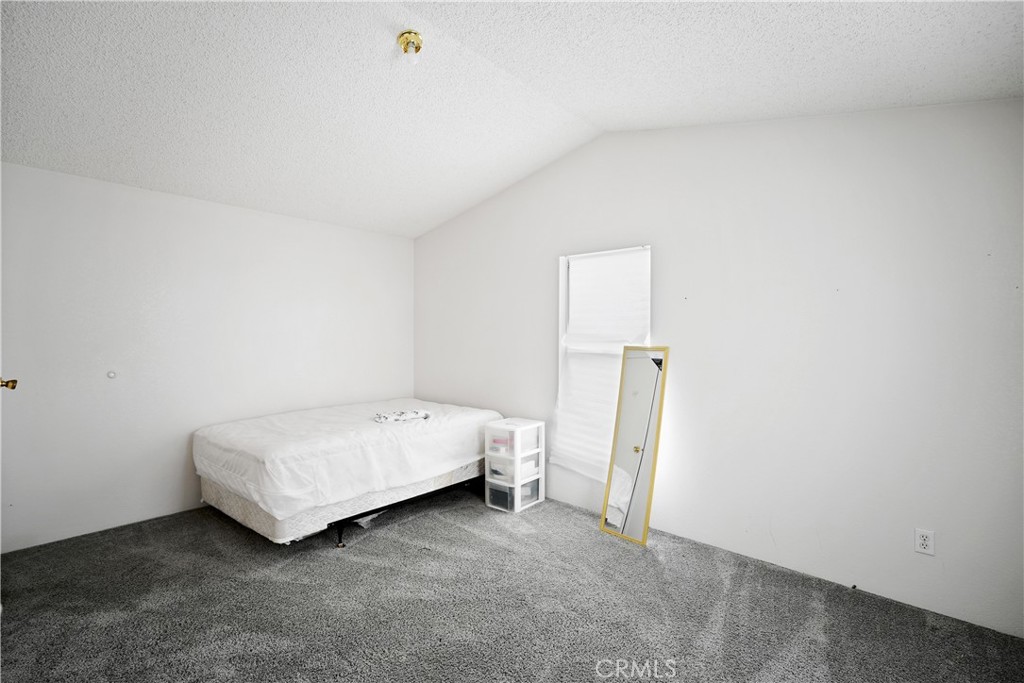 18420 Decker Road Perris, CA 92570 - Photo 11 of 26 a room with a bed and a table