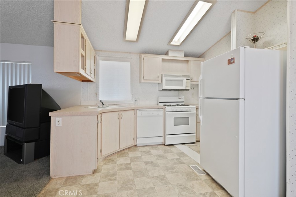 18420 Decker Road Perris, CA 92570 - Photo 14 of 26 a white refrigerator freezer and a stove sitting inside of a kitchen