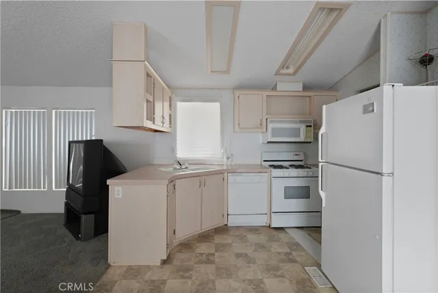 a kitchen with a sink and refrigerator