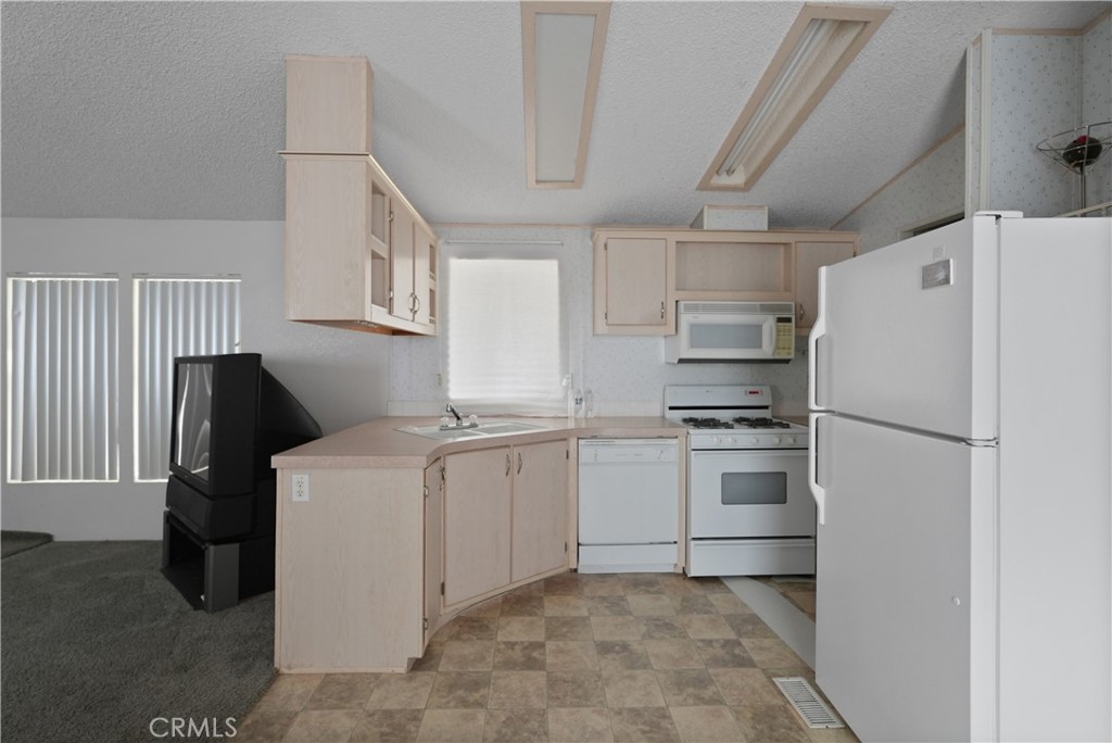 18420 Decker Road Perris, CA 92570 - Photo 18 of 26 a kitchen with a refrigerator sink stove and cabinets