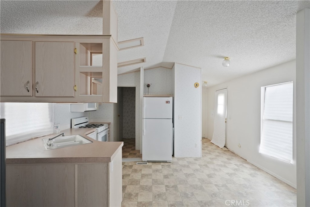 18420 Decker Road Perris, CA 92570 - Photo 19 of 26 a kitchen with a sink and refrigerator