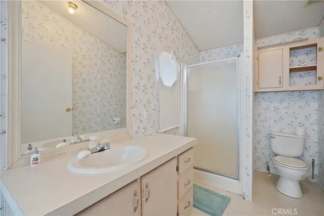 a bathroom with a sink toilet and a mirror