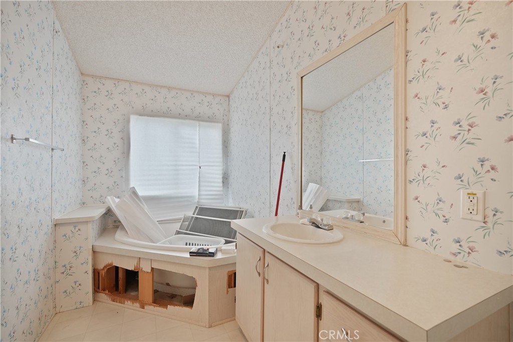 18420 Decker Road Perris, CA 92570 - Photo 5 of 26 a bathroom with a sink vanity and a mirror