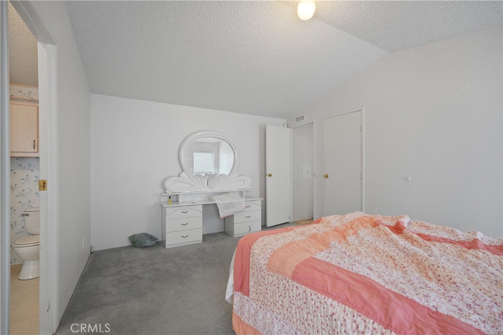 18420 Decker Road Perris, CA 92570 - Photo 6 of 26 a bedroom with a bed and a dresser