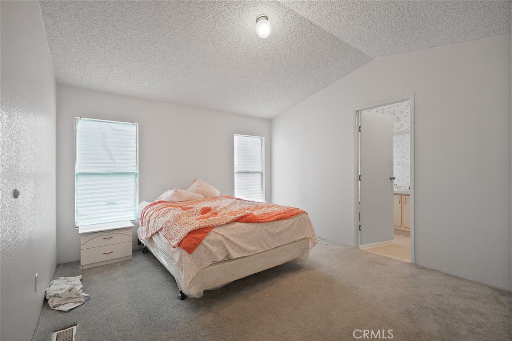 18420 Decker Road Perris, CA 92570 - Photo 7 of 26 a bedroom with a bed and window