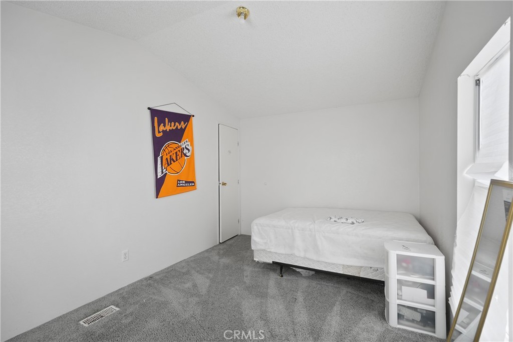 18420 Decker Road Perris, CA 92570 - Photo 10 of 26 a bedroom with a bed and painting on the wall