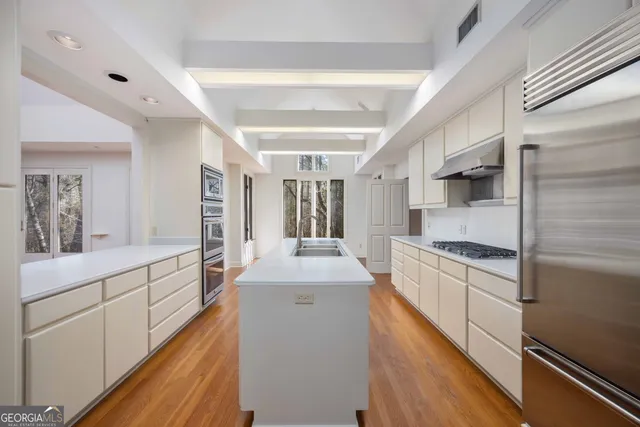 a kitchen with a sink and stainless steel appliances