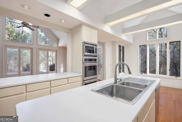 a kitchen with appliances a sink and cabinets