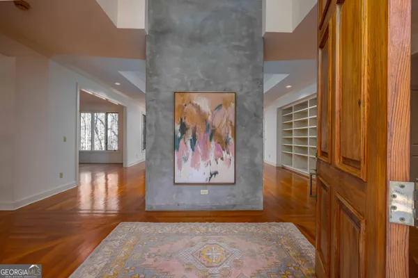 a view of a livingroom with wooden floor and a fireplace