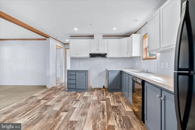 a kitchen with granite countertop white cabinets and stainless steel appliances