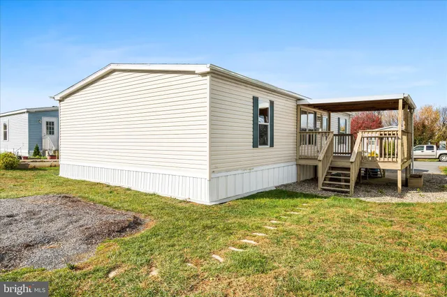 a view of a house with a backyard and a chair