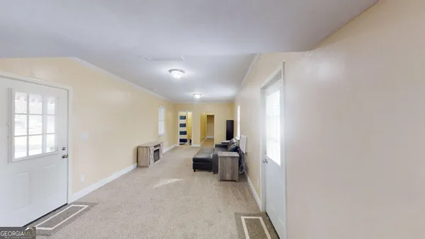 a view of a hallway with furniture and windows