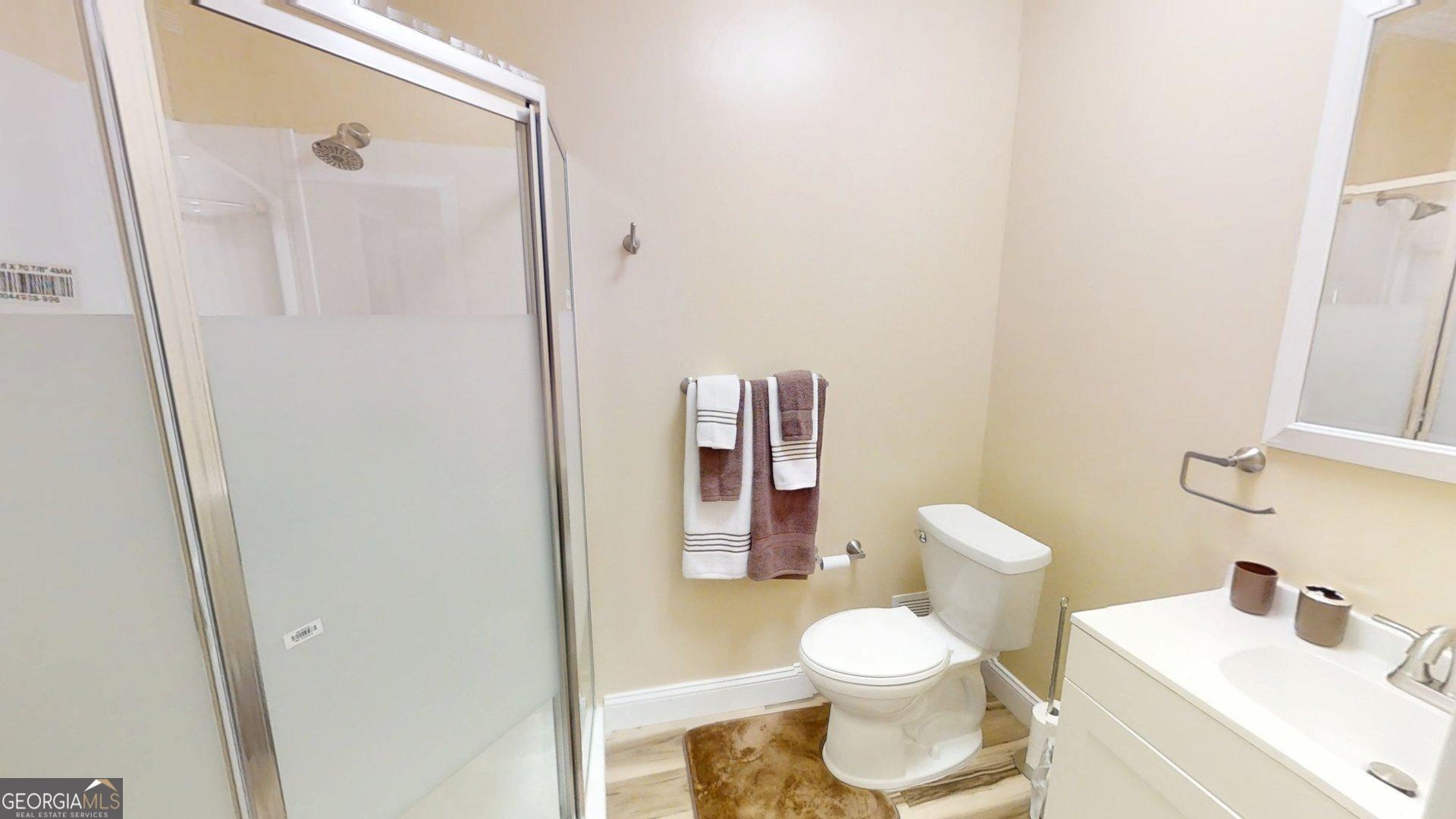 906 Diamond Circle LaFayette, GA 30728 - Photo 20 of 26 a white toilet sitting next to a bathroom sink and a mirror