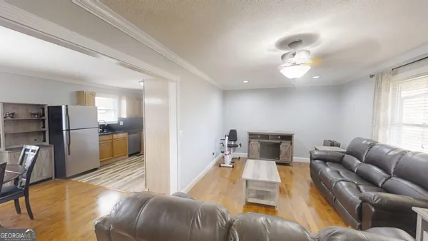 a living room with furniture kitchen and a table