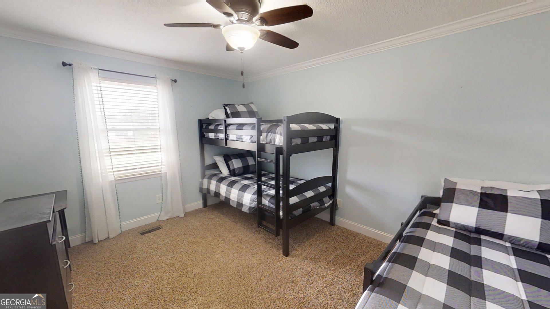 906 Diamond Circle LaFayette, GA 30728 - Photo 10 of 26 a bedroom with a bed and a chandelier