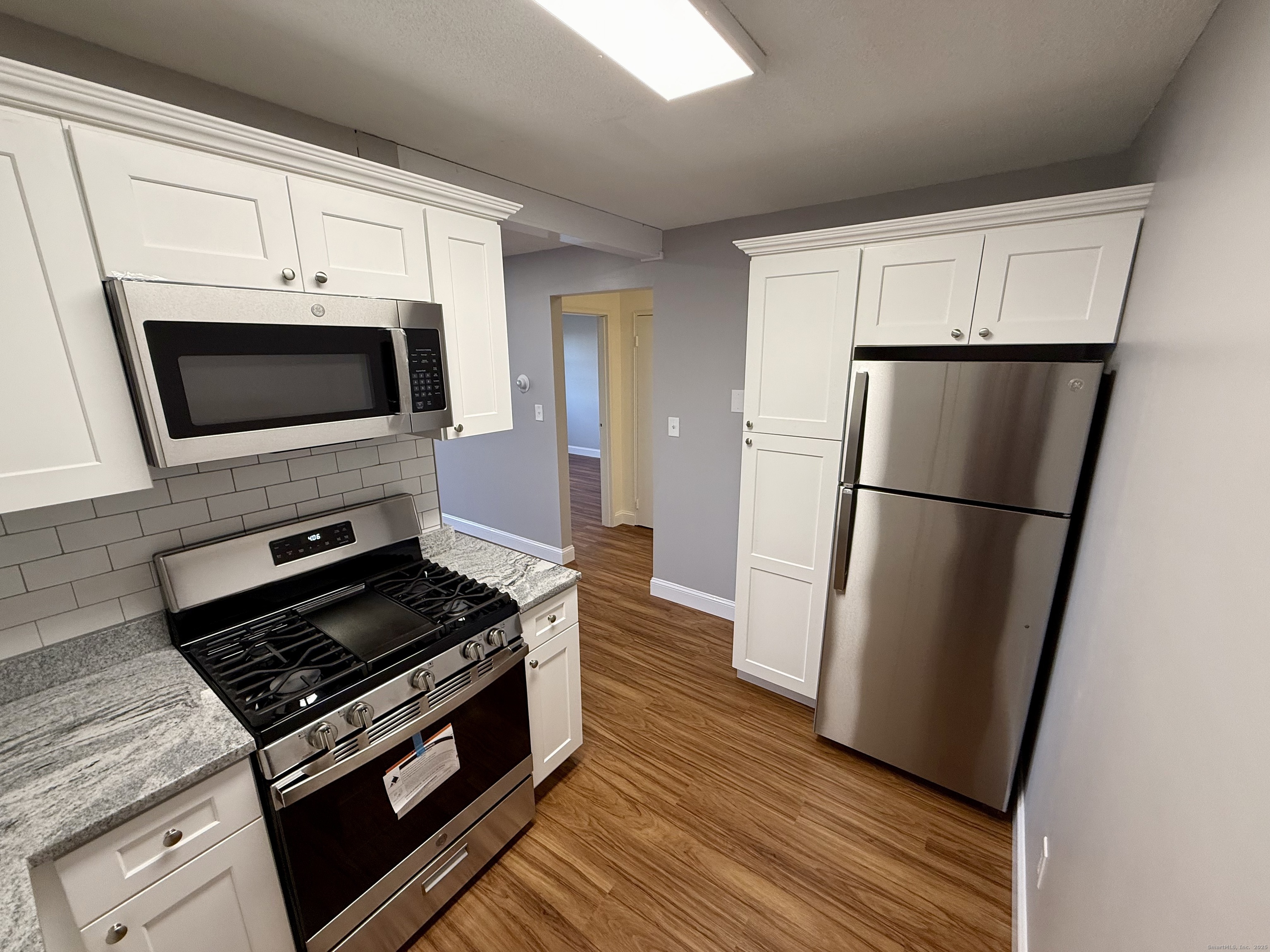 a kitchen with wooden cabinets and stainless steel appliances