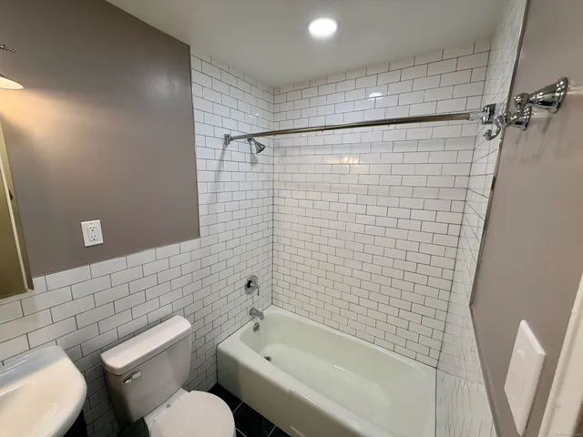 a bathroom with a toilet and shower