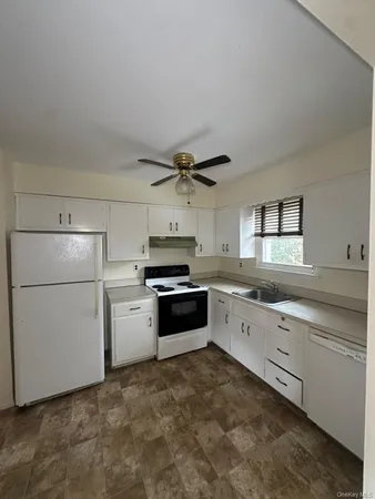 a kitchen with a white cabinets and white appliances