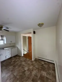 a kitchen with granite countertop a refrigerator and a sink