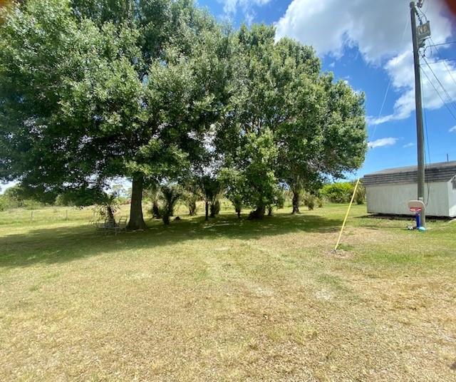 3025 Matthews Road Fort Pierce, FL 34945 - Photo 14 of 35 a house with trees in front of it