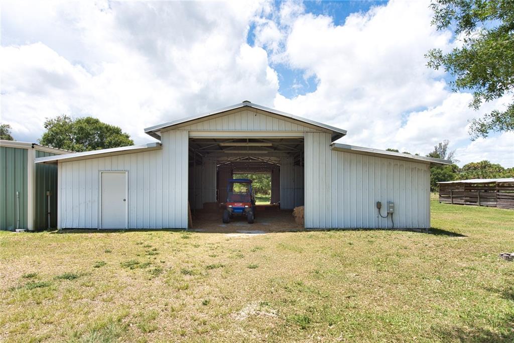 3025 Matthews Road Fort Pierce, FL 34945 - Photo 15 of 35 a front view of a house with a yard