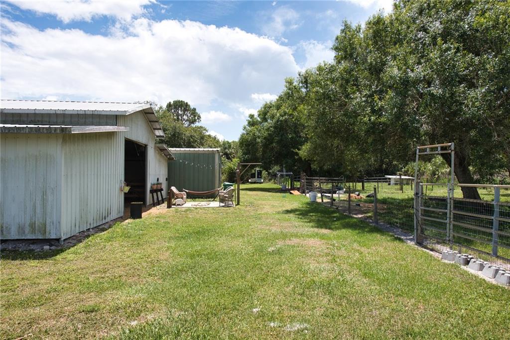 3025 Matthews Road Fort Pierce, FL 34945 - Photo 19 of 35 a view of a backyard with swimming pool