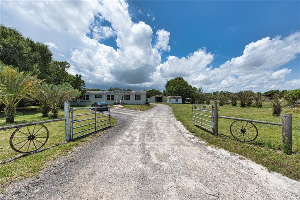 3025 Matthews Road Fort Pierce, FL 34945 - Photo 2 of 35 a view of swimming pool with outdoor seating and a pathway