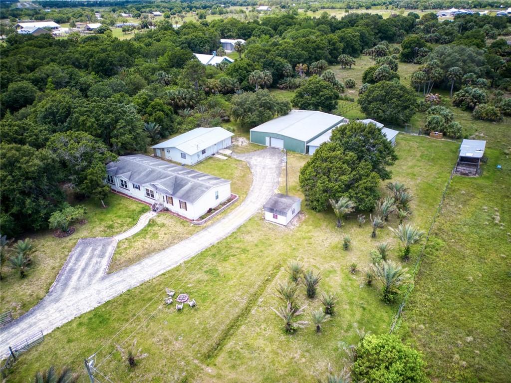 3025 Matthews Road Fort Pierce, FL 34945 - Photo 21 of 35 a view of a swimming pool with lawn chairs and plants