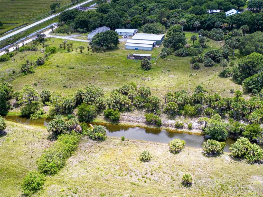 3025 Matthews Road Fort Pierce, FL 34945 - Photo 28 of 35 a view of a garden with a lake