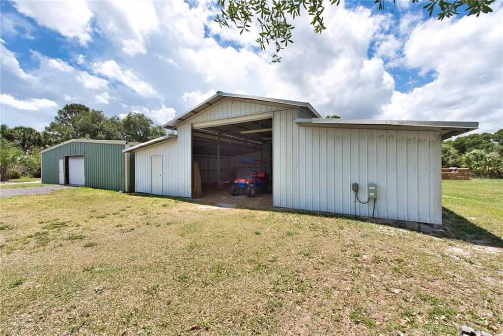 3025 Matthews Road Fort Pierce, FL 34945 - Photo 3 of 35 a front view of a house with a yard and garage