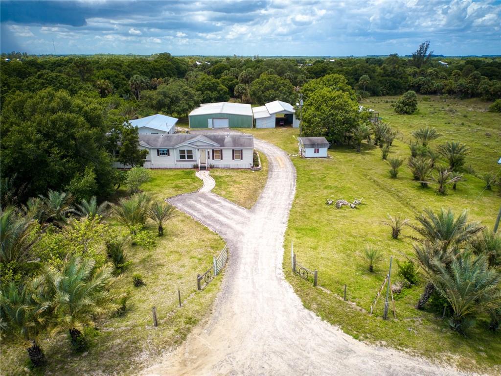 3025 Matthews Road Fort Pierce, FL 34945 - Photo 31 of 35 a view of a swimming pool with a patio and a yard