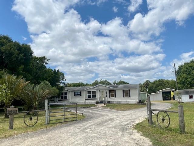 3025 Matthews Road Fort Pierce, FL 34945 - Photo 32 of 35 a front view of a house with a yard