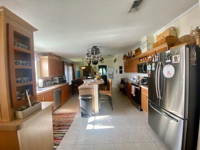 3025 Matthews Road Fort Pierce, FL 34945 - Photo 33 of 35 a kitchen with stainless steel appliances granite countertop a refrigerator and a sink