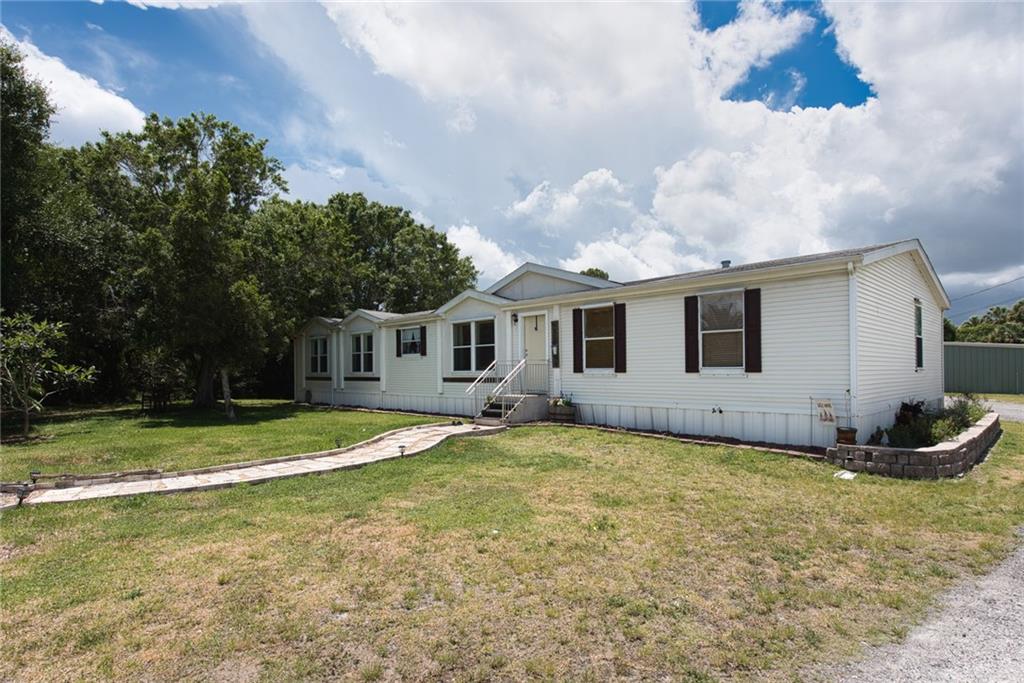 3025 Matthews Road Fort Pierce, FL 34945 - Photo 5 of 35 a view of a house with a yard