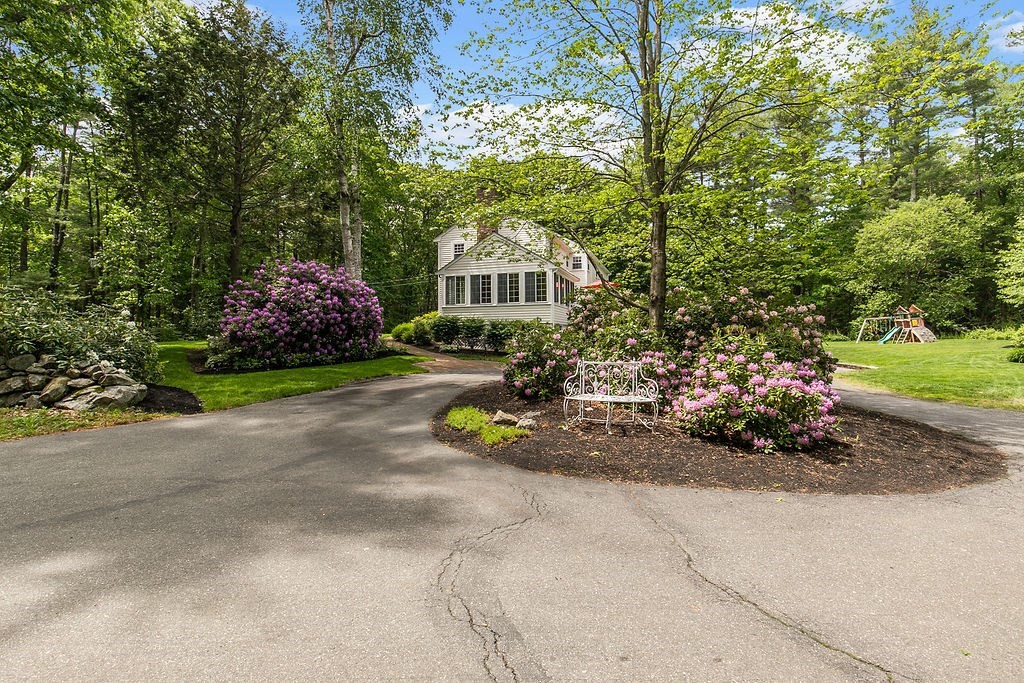 7 Old Bare Hill Road Boxford, MA 01921 - Photo 8 of 42 a view of a house with a garden and pathway