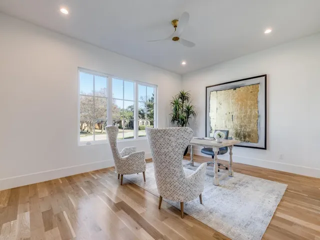 a dining room with wooden floor and a window