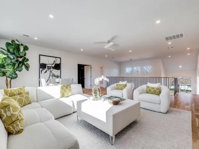 a living room with furniture and a potted plant