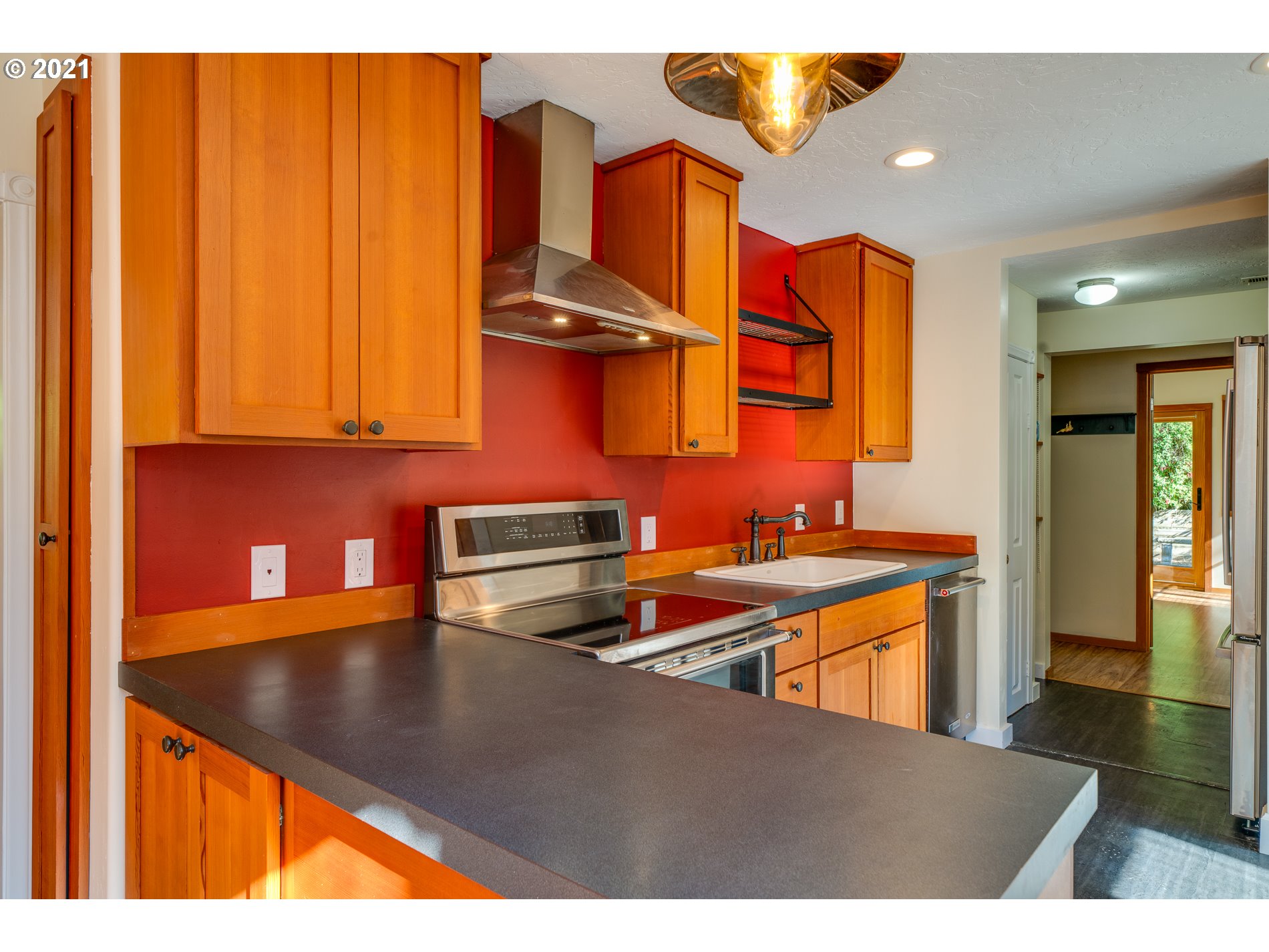 9350 Nehalem Road Nehalem, OR 97131 - Photo 14 of 31 a kitchen with stainless steel appliances granite countertop a sink a stove and a dining table
