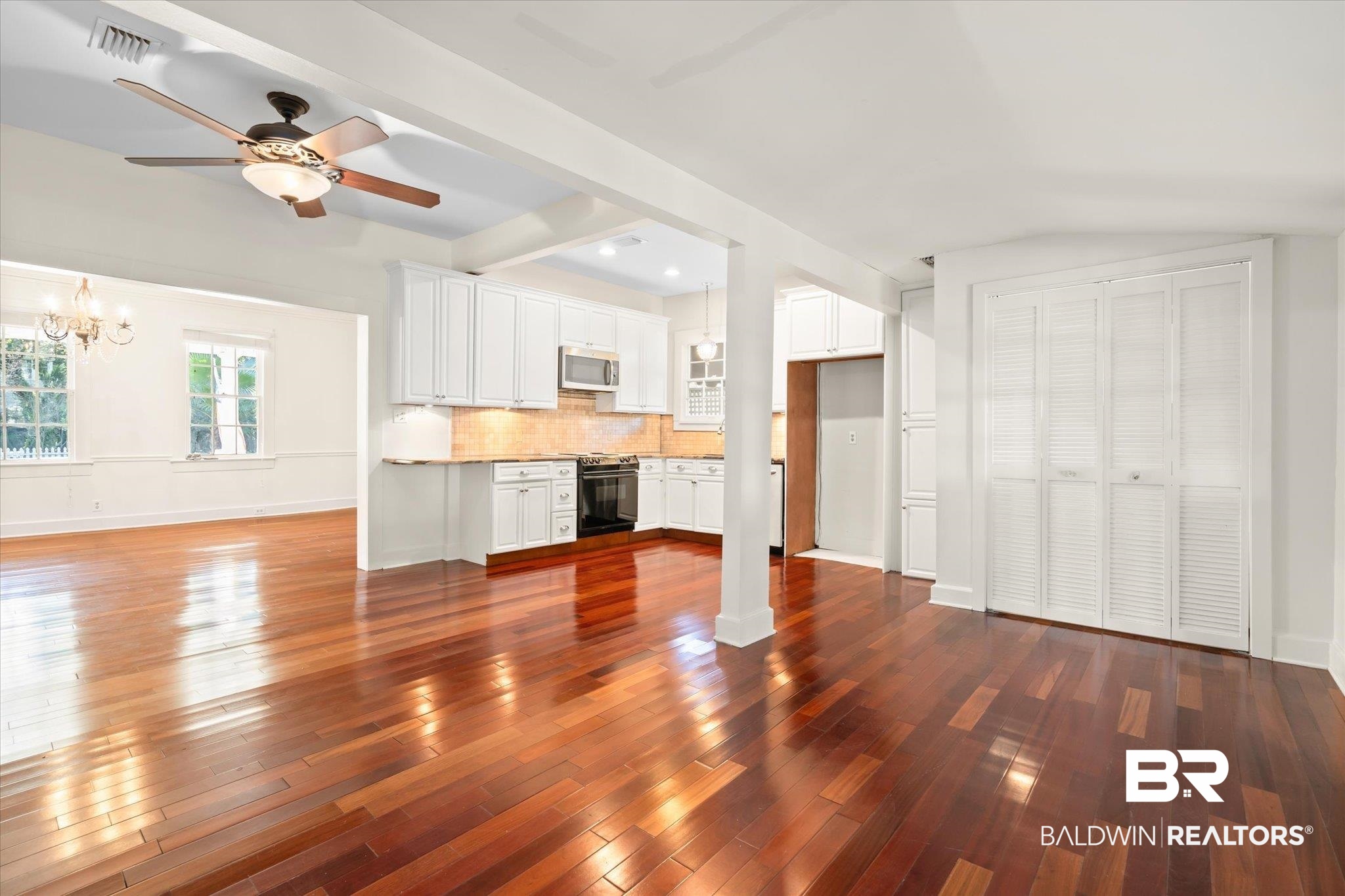 1220 Elmira Street Mobile, AL 36604 - Photo 7 of 20 Unfurnished living room featuring ceiling fan with notable chandelier and dark hardwood / wood-style floors