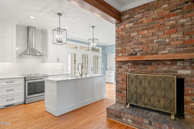 a view of an empty room with window and fire place