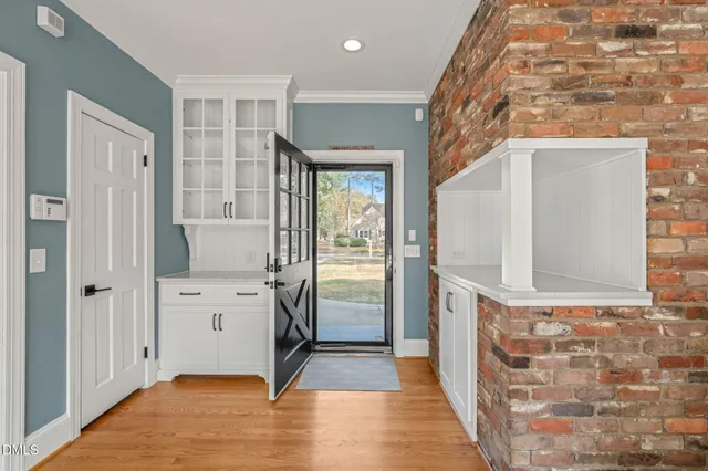 a view of a hallway with wooden floor and staircase