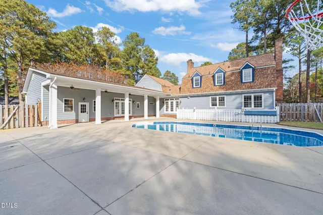 an aerial view of residential houses with outdoor space and trees