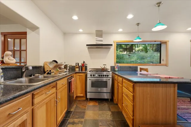 a kitchen with a sink stove and refrigerator