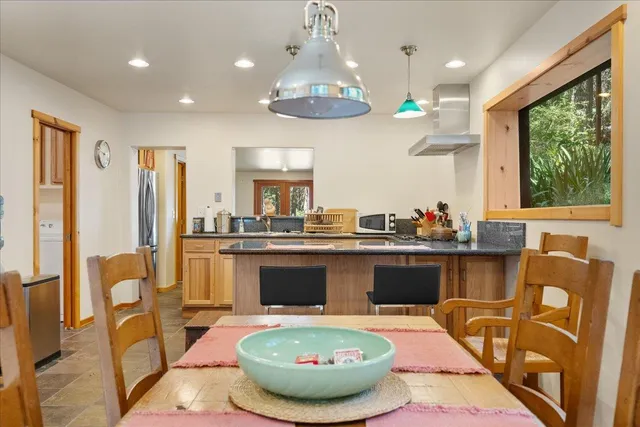 a room with table chairs and a chandelier