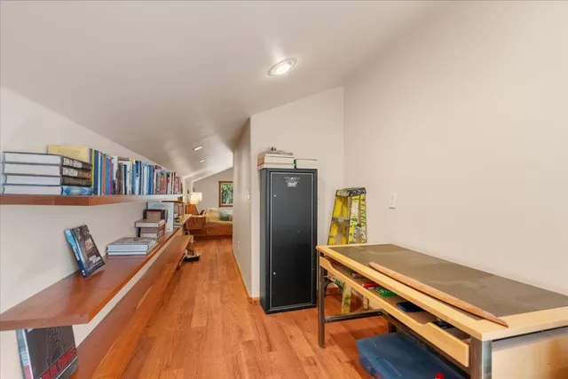 a view of a living room with furniture and wooden floor